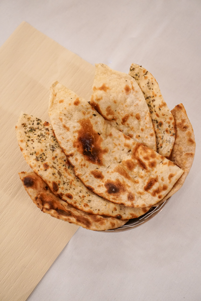 A basket of warm naan and chapati, fresh from the tandoor.